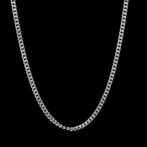 A detailed shot of a handcrafted silver Cuban link chain against a black background.