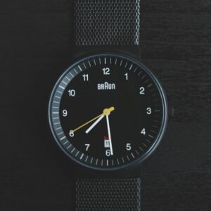 Elegant black wristwatch with a sleek design and precise timekeeping features.